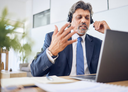 Business man, call center and computer for consultant in communication, sales or virtual meeting. Corporate agent, financial advisor or manager speaking on laptop or video for work from home webinarの写真素材