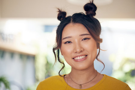 Asian, woman and happy portrait in home with cool gen z person with a smile in kitchen, living room or apartment. Face, happiness and girl with unique fashion, hairstyle or casual confidence in houseの写真素材