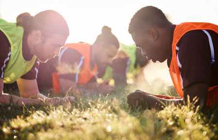 Sports, team and soccer group plank on field for fitness training, workout or core exercise outdoor...