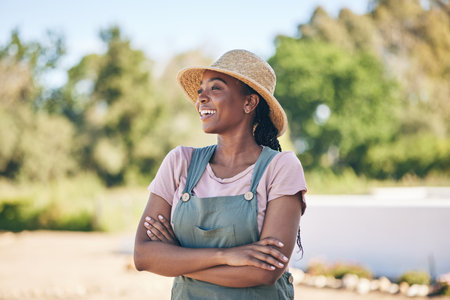 Thinking, black woman and farmer with arms crossed, happy and sustainability outdoor. Idea, agriculture and confident person smile in nature, agro and eco friendly vision in summer garden countrysideの写真素材