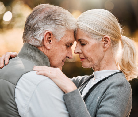 Love, forehead or face of senior couple bonding, slow dance and enjoy quality time together in park, forest or woods. Wellness, nature or elderly people care, support or connect on relax outdoor dateの写真素材