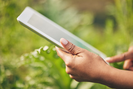 Hands on tablet, research and woman on farm checking internet website for information on plants....