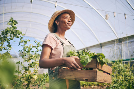 Smile, greenhouse and black woman on farm with vegetables in sustainable business, nature and sunshine. Agriculture, garden and happy female farmer in Africa, green plants and agro farming in field.の写真素材