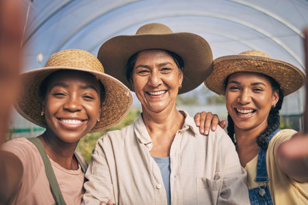 Greenhouse, smile and selfie of group of women in farming, sustainable small business and agriculture. Portrait of happy friends at vegetable farm, diversity and growth in summer with agro farmer.の写真素材