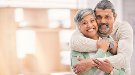 Portrait, hug and old couple with marriage, smile and happiness with bonding, romance and retirement. Home, mature man and senior woman embrace, apartment and mockup space with love, care and supportの写真素材