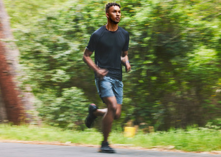 Man running with speed in park for exercise, fitness and power of cardio workout, action and race....