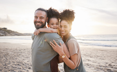 Portrait, hug and family with sunset, beach and love with vacation, journey and ocean getaway. Happy parents, mother or father with girl, child or embrace with seaside holiday, adventure and travelの写真素材