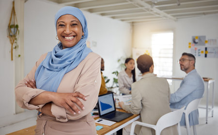 Ceo, Muslim woman and arms crossed portrait of business manager in a office with a smile. Company leader, management and mature female professional with a hijab ready for a website team meetingの写真素材