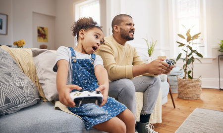 Dad, girl and video game controller on sofa with challenge, shout and wow in competition, bonding and house. Man, daughter and excited with esports, contest and funny with strategy in family homeの写真素材