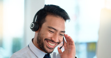Call center agent consulting a buyer via video call in an office. A young friendly sales man talking...