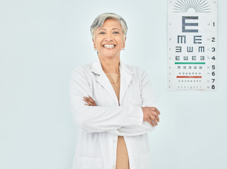 Portrait, ophthalmologist and woman arms crossed in hospital mockup space for healthcare of vision....