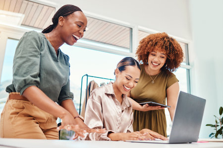 Happy, employees and working together on tech in office with creative, stylist ideas for fashion and clothing on pc or tablet. Funny, colleagues or women in Colombia reading or typing on laptopの写真素材