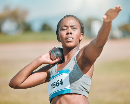 Shot put, athlete and woman in throw competition, championship or training for field event with metal or steel weight. Throwing, ball or African female outdoor for athletics sports or olympicsの写真素材