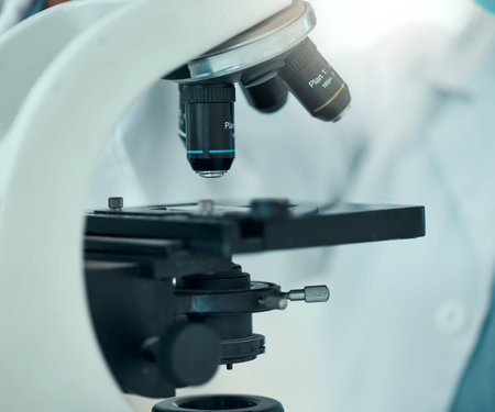 Microscope, science and laboratory with closeup and analysis, pathology and investigation with...