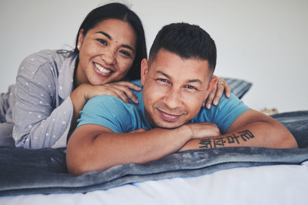 Portrait, bed or happy couple in home with love, care or support while bonding to relax in home...