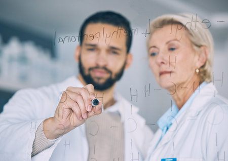 Hand, science and research team writing on glass in the laboratory for planning or study. Healthcare, medical and scientist doctors in a lab together for formula development of future innovationの写真素材