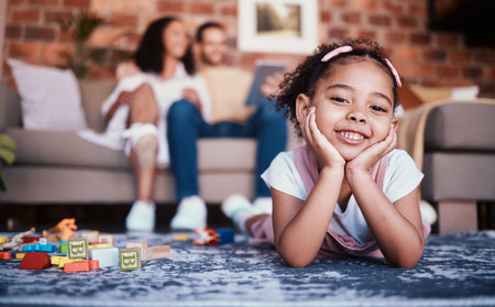 Child, toys and playing portrait in home with development and building block in living room. Family, youth smile and happy young girl with parents in a house together with care and kids learningの写真素材