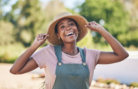 Smile, portrait and black woman on farm in nature, sustainable business and sunshine. Agriculture, gardening and happiness, face of female farmer in Africa with green plants and outdoor agro farming.の写真素材