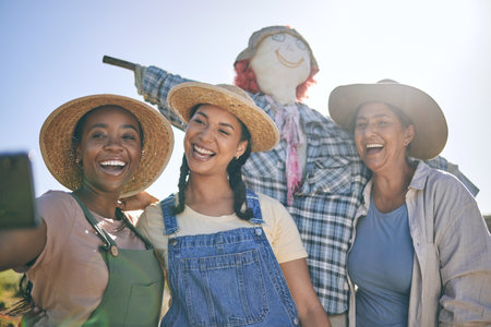 Women, agriculture and group selfie in summer with smile, scarecrow or funny memory for web blog in farming. Female teamwork, agro job and photography in nature, happy and comic laugh on social mediaの写真素材