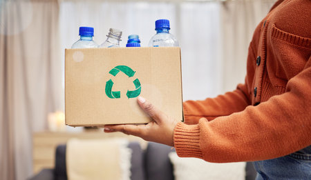 Plastic, recycle and hands with bottle in box in living room for eco friendly, reuse and renewable...