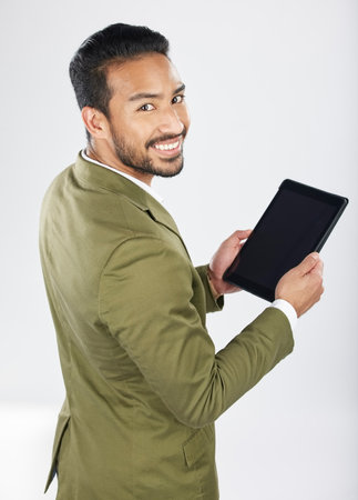 Smile, tablet and portrait of businessman with technology with internet isolated in a studio white background. Online, planning and young person or employee working on connection or networkingの写真素材