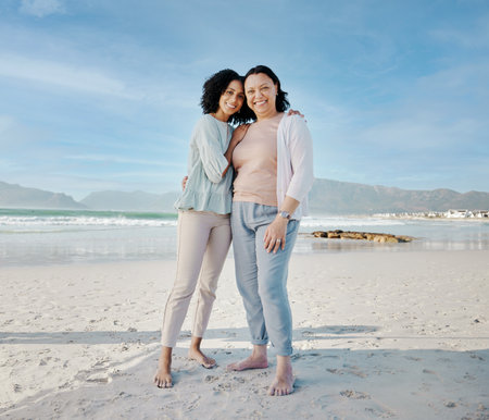 Hug, portrait and woman with mother at a beach happy, bond and relax in nature together. Love, smile and lady face with mom the ocean for freedom, travel and adventure trip at the sea in South Africaの写真素材