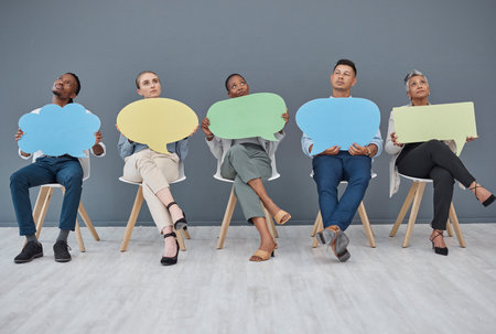 Thinking, office and business people with a speech bubble for social media, chat or contact information. Mockup, sitting and diversity of employees with a board for ideas, communication or opinionの写真素材