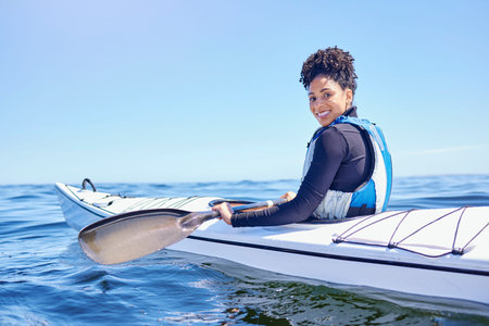 Water, sports and portrait woman in kayak at lake, beach or river for exercise, race or challenge....