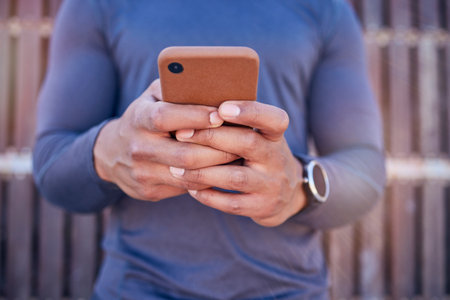 Communication, phone and closeup of hands typing a text message on social media or mobile app. Technology, online and man scroll or chatting on the internet for blog or website with a cellphone.の写真素材