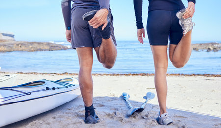 Beach legs, rowing and stretching people, partner or couple of friends for fitness, teamwork and start workout routine. Nature, sports challenge or back of kayaking team training, exercise or warm upの写真素材