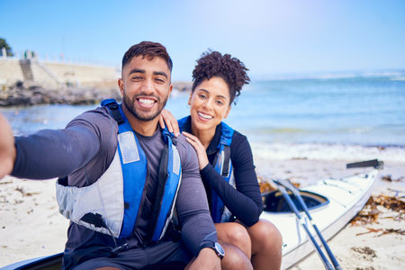 Selfie, kayak and a couple on the beach to relax in summer together for freedom, vacation or holiday travel. Portrait, love or smile with a sports man and woman on a boat by the ocean for adventureの写真素材