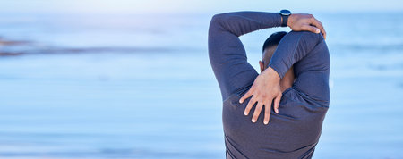 Back, beach and man with fitness, stretching and exercise with warm up, training and cardio sport routine. Person, outdoor or athlete stretch arms, workout and prepare to start activity with wellnessの写真素材