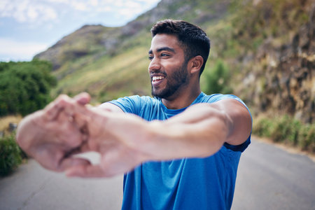 Hands, stretching and happy in a road for fitness, training or morning cardio routine in nature. Body, stretch and male runner outdoor for health, exercise and running, workout and performance goalの写真素材