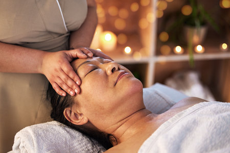 Relax head massage and senior with man in spa for wellness, facial treatment and hospitality. Peace, cosmetics and salon with customer and masseuse in hotel for health, vacation and physical therapyの写真素材