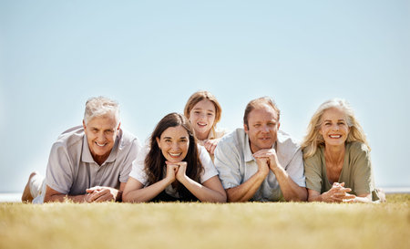 Family, generations and portrait, people outdoor on lawn with grandparents, parents and child....