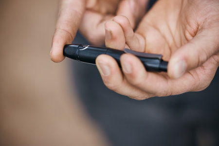 Glucose, finger and hands with needle for diabetes, analysis and blood sugar test, check and monitor. Healthcare, medical care and closeup of person prick for wellness, medicine and inspectionの写真素材