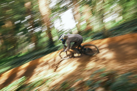 Bicycle, man and forest speed blur for workout outdoor in woods for healthy body. Mountain bike, nature and athlete training, cycling fast or off road adventure on journey, exercise or sport travelの写真素材