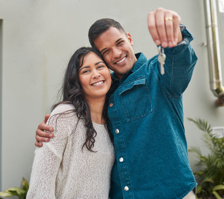Happy couple, portrait and real estate with keys to building, new home or property investment together. Man and woman or homeowners smile for moving in, buying or asset loan in finance and investingの写真素材