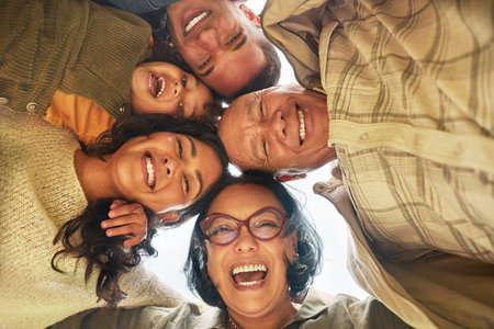 Family, park and portrait of hug below with happy, bonding and smile outdoor on vacation. Huddle,...