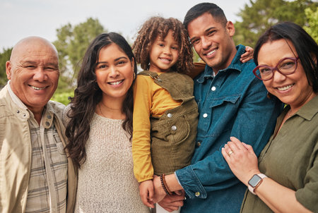 Happy family, grandparents and parent with kid in a park together and happy for vacation or outdoor vacation. Smile, portrait and mother bonding with child and father in nature for summer travelの写真素材