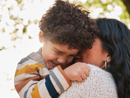 Nature, love and mother with child hugging, playing and bonding at an outdoor park on adventure. Happy, smile and young mom embracing and laughing with her boy kid in a green garden on a weekend.の写真素材