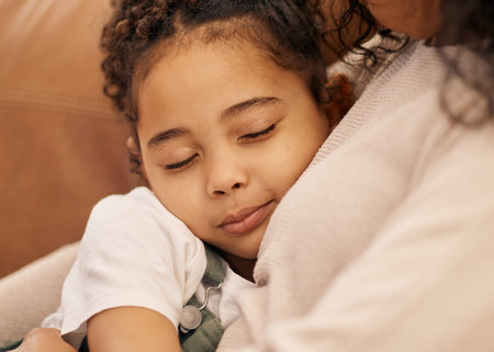 Sleeping, love and face of a girl with her mother closeup in the living room of their home together...