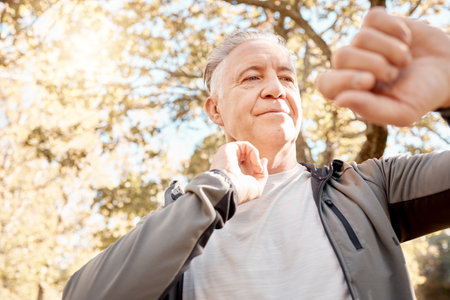 Senior man, check heart rate and smart watch for run, thinking and breathing for training goals in parkpul. Elderly runner, iot clock and outdoor for exercise, workout or fitness and pulse in natureの写真素材