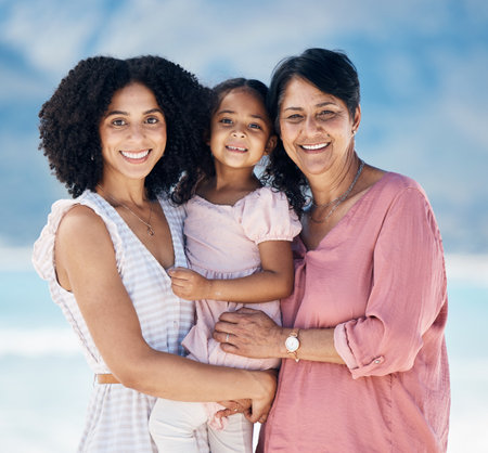 Mom, grandma and girl in beach portrait, smile and hug with care, love and generations on vacation in sunshine. Mature woman, happy mother and daughter for bonding, summer and holiday together by seaの写真素材