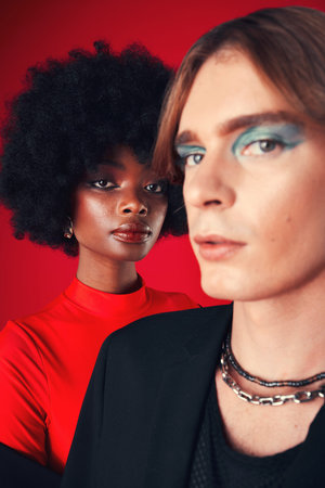 Makeup, beauty and portrait of people with diversity in fashion on red background in studio with...