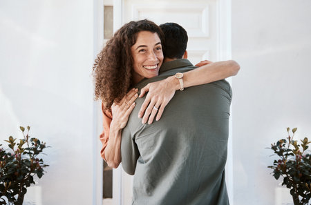 Smile, love and a couple hugging in their home for support, care or romance in marriage together. Happy, trust and security with a woman embracing her husband in their house for relationship bondingの写真素材