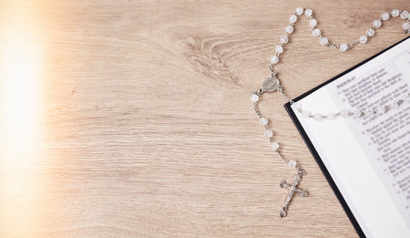 Rosary, table or bible study for faith, studying religion and mindfulness with holy spiritual scripture. Christian literature, background or story for education or knowledge on God or Jesus Christの写真素材