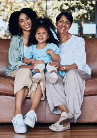 Grandma, mother and daughter on sofa, portrait and smile with care, love and bonding in family house. Mom, grandmother and child with generations, embrace and happy for memory, living room and houseの写真素材