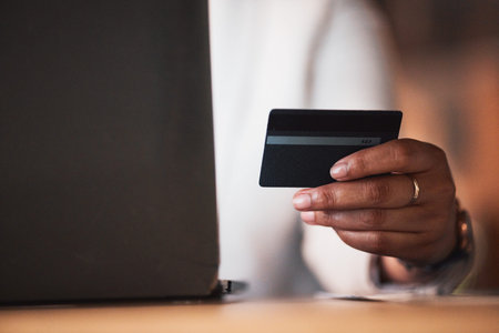 Hand, credit card and laptop, person and e commerce with payment, fintech and account, internet and...