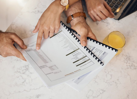 Hands, documents and a couple in the kitchen to budget for finance, investment or savings in a home...